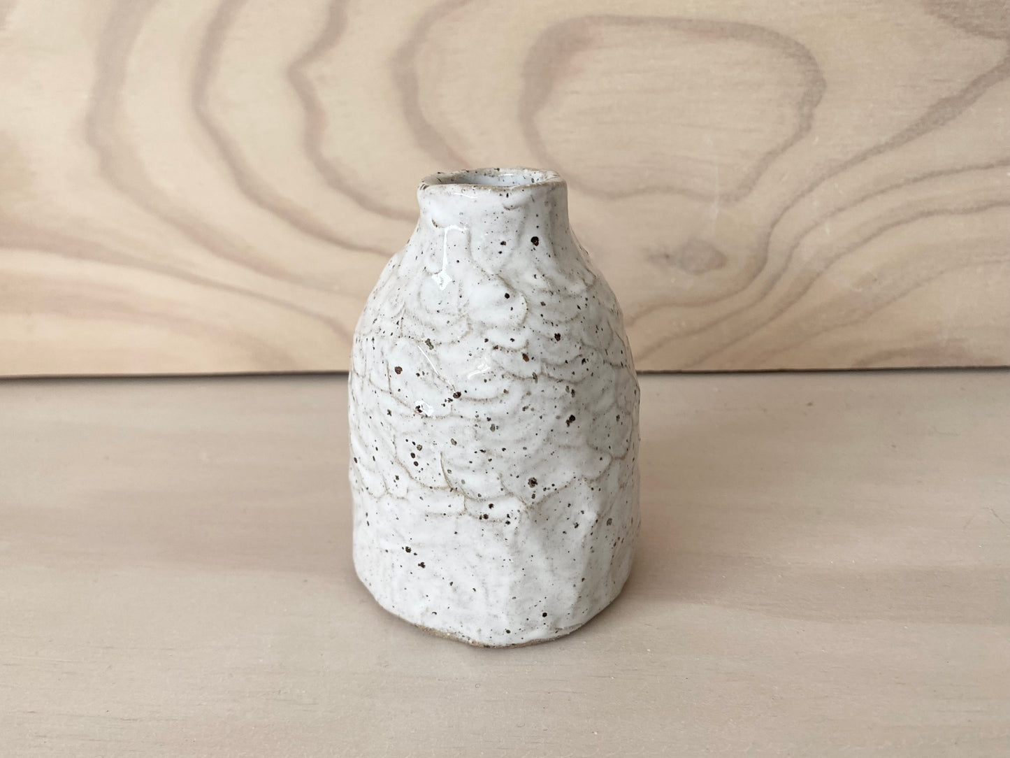 Speckled white bud vase
